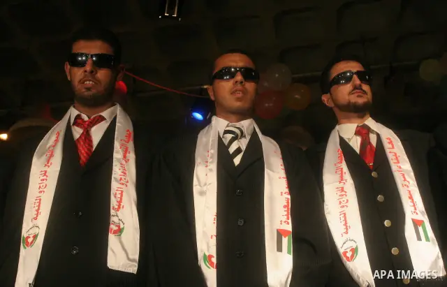 Visually-impaired Palestinian grooms take part in a mass wedding in Gaza City on August 2, 2009. Over 40 couples got married during the event which was sponsored by the Hamas-affiliated Taysir Association. Photo By Moham...