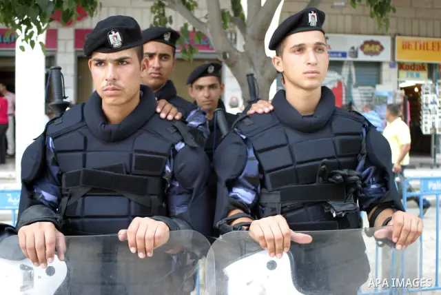 Members of the Palestinian security forces stand guard outside the Fatah congress in the West Bank town of Bethlehem August 10, 2009. Photo by Najeh Hashlamoun
