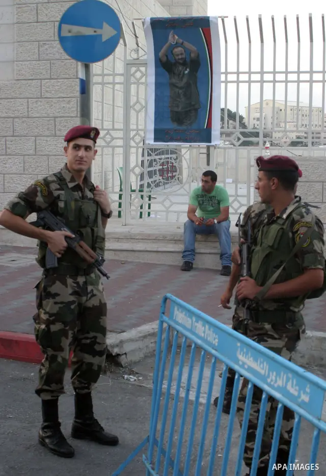 Members of the Palestinian security forces stand guard outside the Fatah congress in the West Bank town of Bethlehem August 10, 2009. Photo by Najeh Hashlamoun