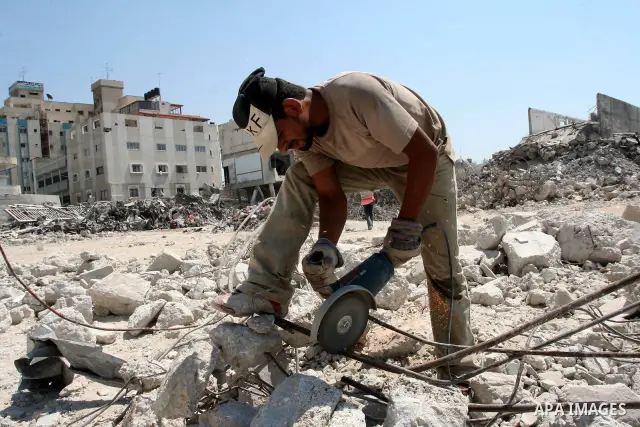 Palestinian workers remove the rubble of the security headquarters "Saraya" which destroyed during 22 days of israeli offensive, in Gaza city on August 11, 2009. Photo By Mohammed Asad