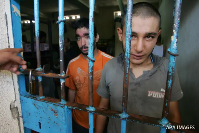 A Hamas police bring new inmates to the prison controlled by the Hamas police in Gaza City on August 11, 2009. The detention facility was opened after Gaza's main prison was destroyed during Israel's 22-day military offe...