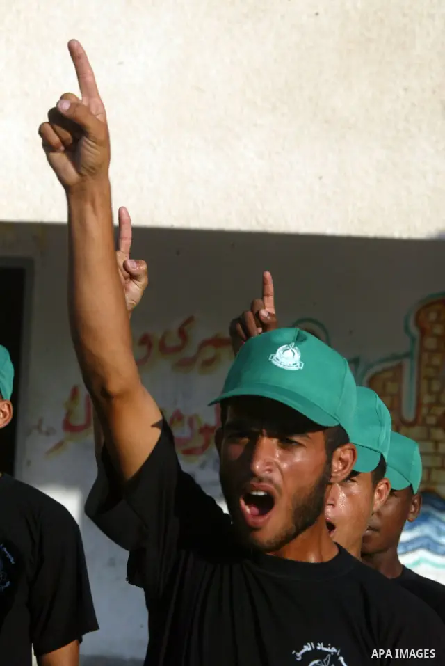 Palestinian boys from a Hamas summer camp exercises in formation with wooden guns in Rafah southern Gaza strip on August 11, 2009. Hamas holds summer camps throughout the Gaza Strip, where participants from 14 to 17 year...