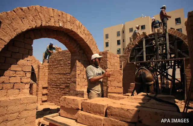 A Palestinian worker uses clay bricks to rebuild a Hamas police station in Beit Lahiya in the northern Gaza Strip August 12, 2009. The police station was destroyed during the three-week offensive Israel launched last Dec...