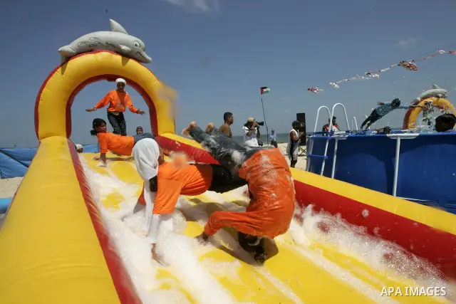 Palestinian children attend a summer games activity sponsored by the United Nations Relief and Works Agency (UNRWA) in Khan Younis town in the southern Gaza Strip, on August 13 2008. Many children have found relief at su...