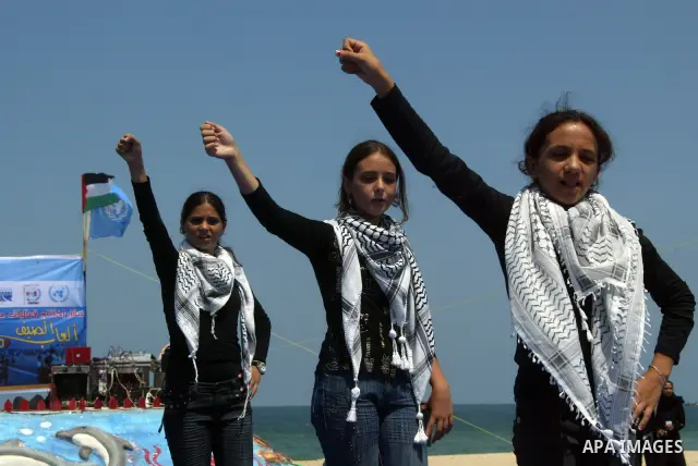 Palestinian children attend a summer games activity sponsored by the United Nations Relief and Works Agency (UNRWA) in Khan Younis town in the southern Gaza Strip, on August 13 2008. Many children have found relief at su...