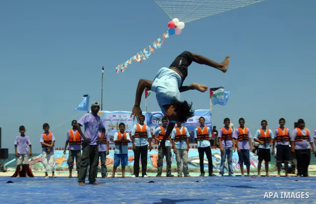 Palestinian children attend a summer games activity sponsored by the United Nations Relief and Works Agency (UNRWA) in Khan Younis town in the southern Gaza Strip, on August 13 2008. Many children have found relief at su...