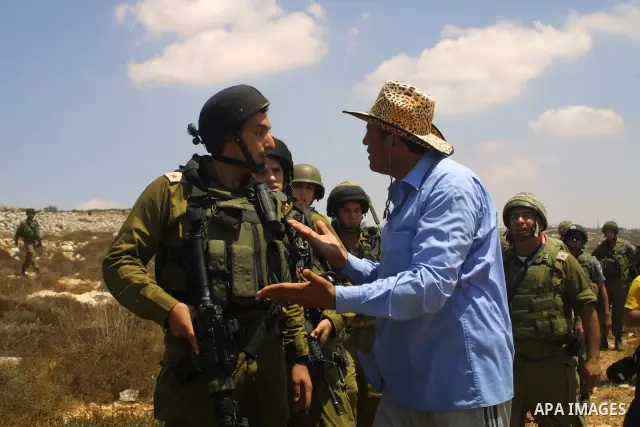 Palestinians scuffle with Israeli soldiers during a protest against the confiscation of land by the Jewish settlement of Bracha in the West Bank village Burin, near Nablus on Aug 14, 2009. Photo by Nedal Shtieh