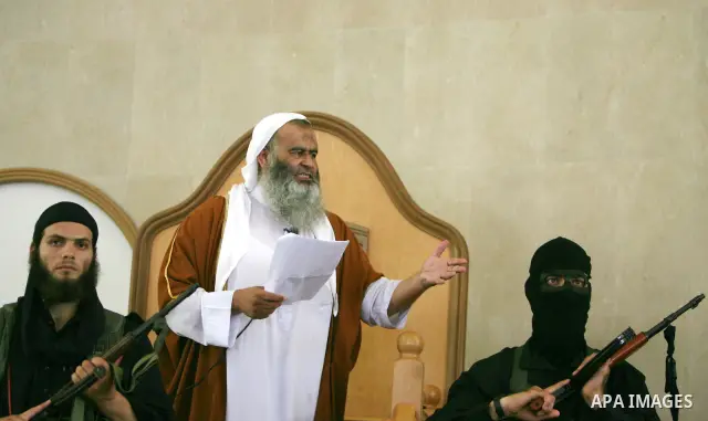 Abdel Latif Musa (L), a representative the radical Palestinian Islamist group Jund Ansar Allah, is guarded by an armed member of his radical group as he delivers the Friday prayer sermon at a mosque in the southern Gaza...