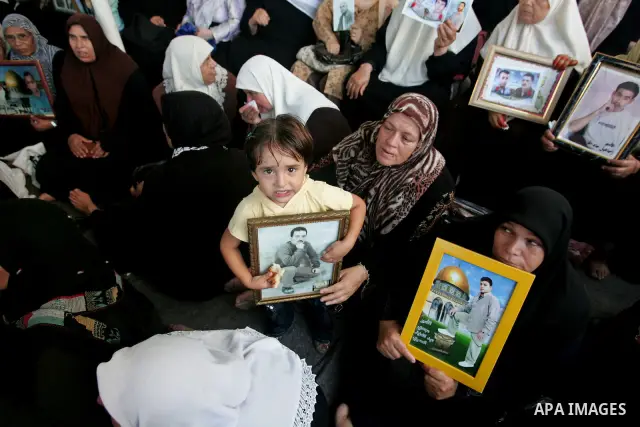 Palestinians take part in a protest in Gaza City calling for the release of Palestinian prisoners from Israeli jails August 17, 2009. Some 11,000 Palestinians are in Israeli prisons and securing their freedom is a highly...