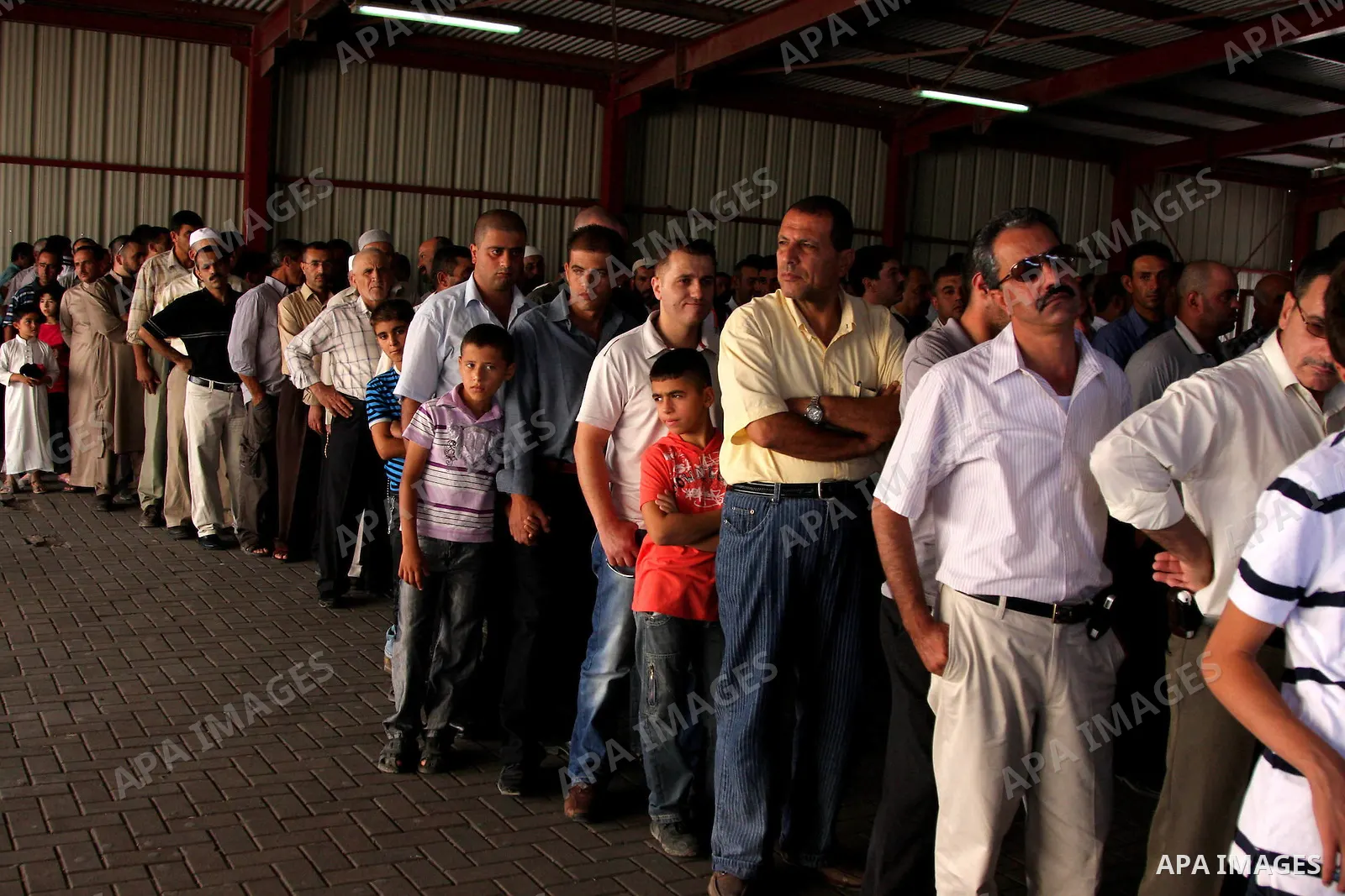 A Palestinians wait to cross an Israeli checkpoint of Qalandiya near the West Bank city of Ramallah on Aug 28, 2009, as they try to reach the al-Aqsa mosque in Jerusalem on the first Friday of the Muslim holy month of Ra...