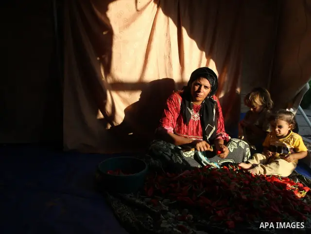 A palestinian woman Wafa Awaja, 46, prepares cooking to break their fasting in a tent used as temporary shelter in northern Gaza Strip town of Beit Lahiya on Sep 2,2009. Awaja's son was shot dead during Israeli's Decembe...