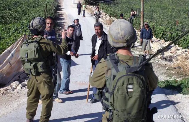 An Israeli soldier clashes with an Palestinian who tried to prevent the army from demolishing several large water reservoirs on a Palestinian farm near the West Bank city of Hebron September 03, 2009. According to Israel...