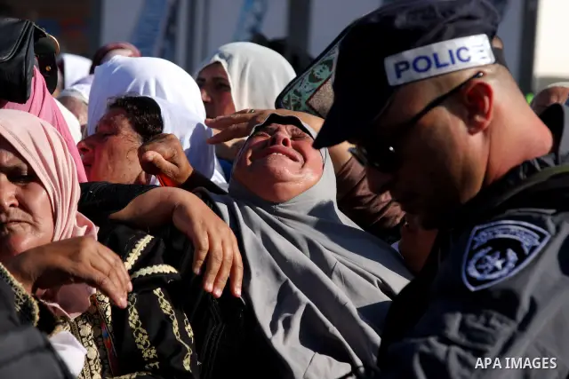 Palestinian woman cry during cross the Israeli Qalandia checkpoint, on their way to attend prayers in the Al-Aqsa Mosque compound in Jerusalem, Friday Sep 11, 2009, the third Friday of the Muslim holy month of Ramadan. I...