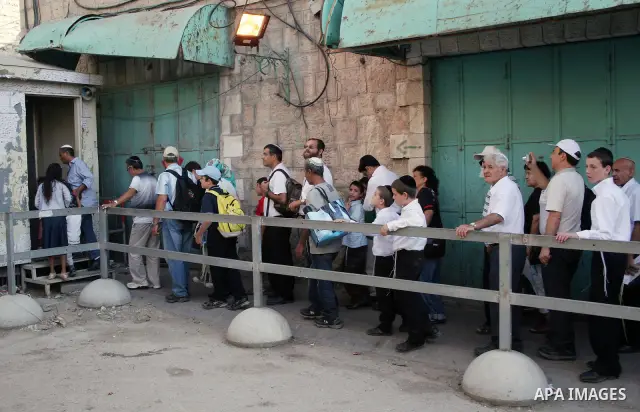 Jewish settlers as they walk in the West Bank city of Hebron October 4, 2009.Photo by Najeh Hashlamoun