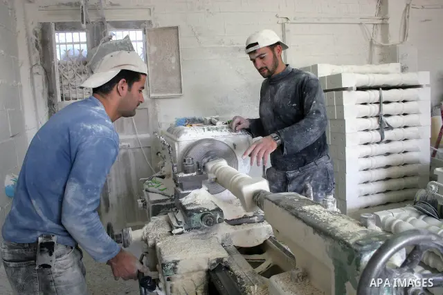 Palestinian workers carve marble stone for housing building in the West Bank city of Hebron October 05, 2009. Photo by Najeh Hashlamoun