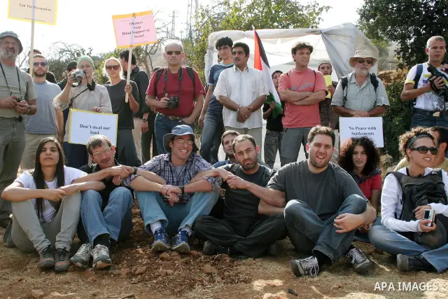 Palestinians, Israelis and foreign activists attend a protest against Jewish settlement within the West Bank near Kiryat Arba settlement in the West Bank city of Hebron October 23, 2009. Photo by Najeh Hashlamoun