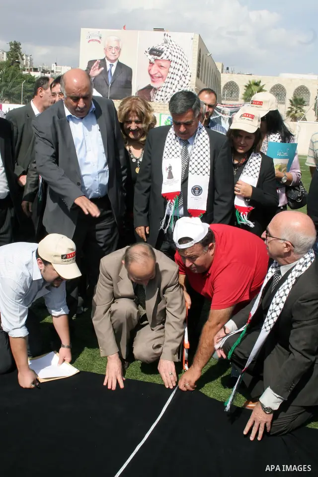 Palestinians display the largest traditional Palestinian dress it will be to create the largest traditional Palestinian dress in an attempt to enter the Guinness World Records at Al-Hussein stadium in the West Bank city...