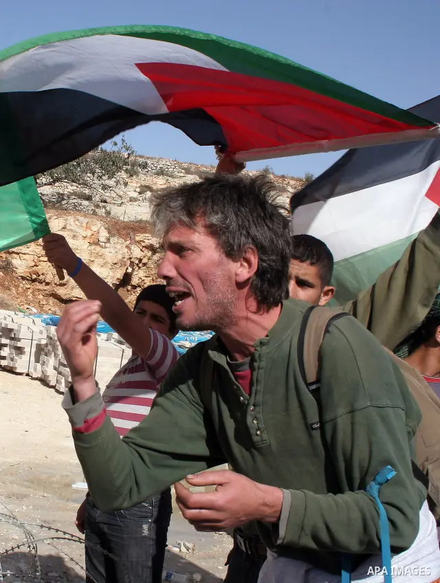Israeli soldiers stand guard opposite Palestinian and foreign activists during a protest against Israel's controversial separation barrier in the West Bank village of Maasarah, near Bethlehem, on November 06, 2009. Photo...