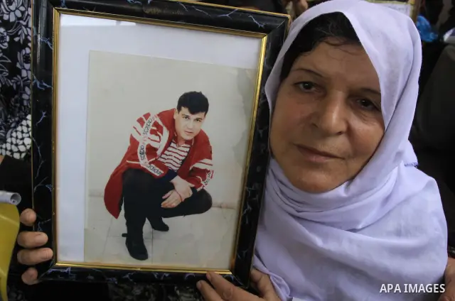 Palestinians hold pictures of their relatives jailed in Israeli prisons during a weekly protest in Gaza City on Nov 9, 2009 to call for their release. Currently Israel is holding 11,000 Palestinians in its jails. Photo B...