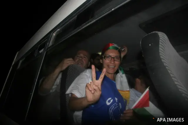 Woman from the "Miles of Smiles" convoy, waves with victory sign as she arrives to Gaza City on November 11, 2009.The European medical aid convoy from "Miles of Smiles" that was prohibited from delivering its cargo to Ga...