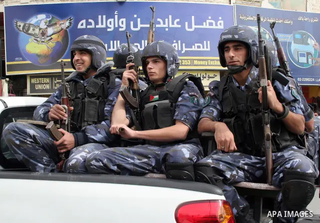 Palestinian police troops parade in the West Bank town of Hebron on 16 November 2009 during a rally marking the symbolic declaration of independence Day. Photo by Najeh Hashlamoun
