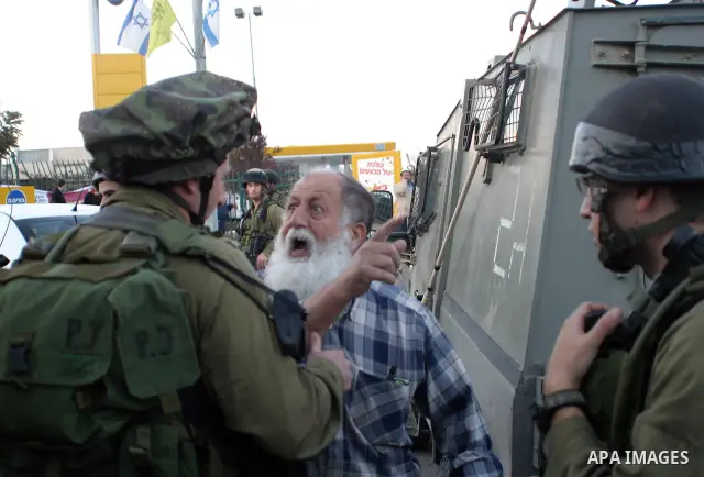 Jewish settler reacts as Israeli police and soldiers secure the scene of a stabbing incident involving settlers and a Palestinian at a gas station near the Israeli settlement of Kiryat Arba'a on the outskirts of the occu...