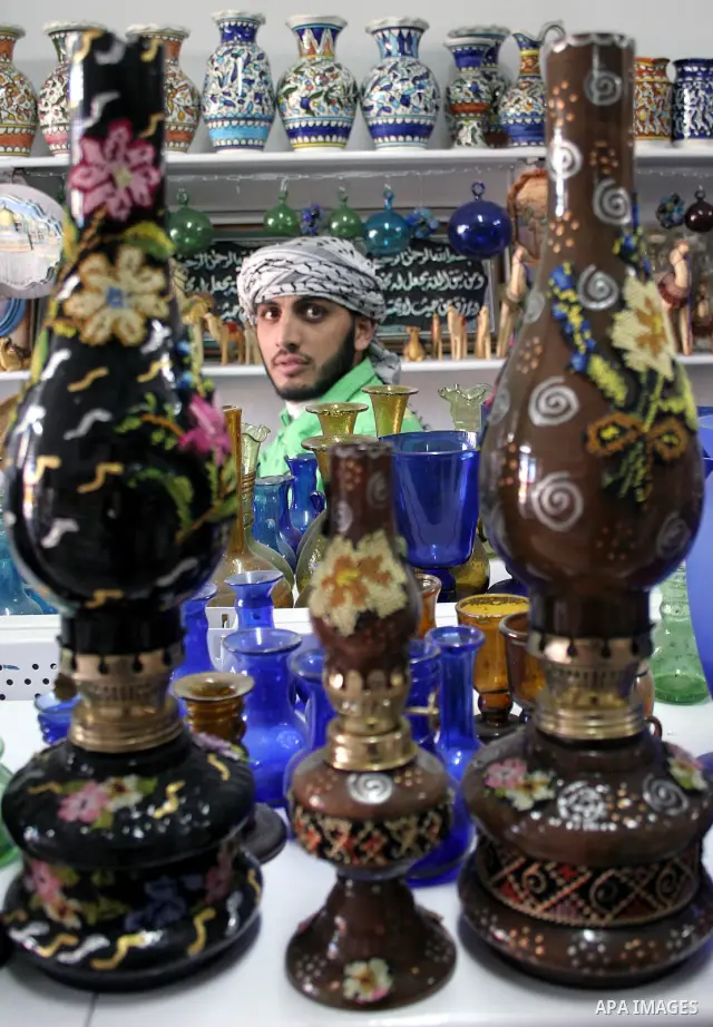 Palestinian Worker decorating on the ceramics in the West Bank city of Hebron on 01 December, 2009. This factory creates artifacts and Judaic made of glass and ceramics . these kinds of products are main products that th...