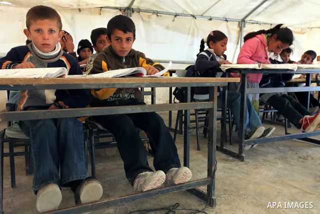 Palestinian students attend class in their tent classroom in the northern Negev Desert village of Al-Fakhet, south of Hebron on 02 December 2009. Some 35 students have to attend school in a tent as Palestinians are not a...