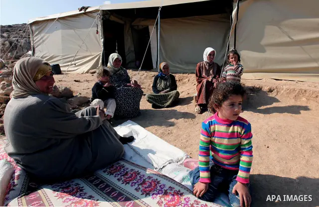 Palestinian women and children sit outside tents in in a mountainous area outside the southern town of Yatta near Hebron in the occupied West Bank on December 5, 2009. Palestinian residents of the area have returned to t...
