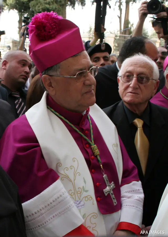 Latin Patriarch of Jerusalem Fouad Twal, center, walks towards the Church of Nativity, traditionally believed by Christians to be the birthplace of Jesus Christ, in the West Bank town of Bethlehem, Thursday, Dec. 24, 200...