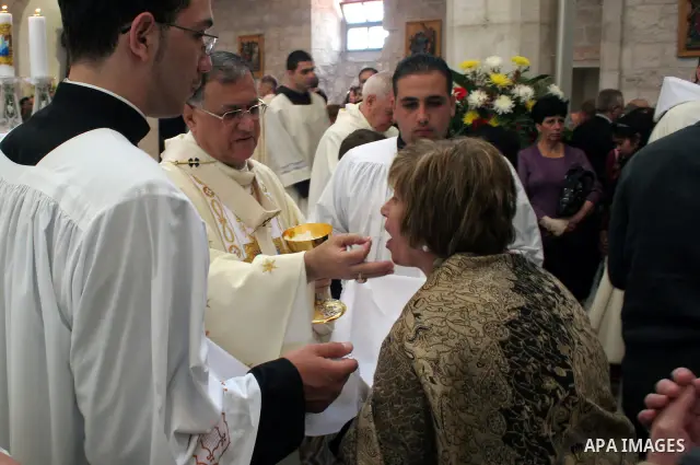 Latin Patriarch of Jerusalem Fuad Twal (C) leads the Christmas mass at the Church of the Nativity in the West Bank town of Bethlehem on 25 December 2009. Twal, the top Roman Catholic cleric in the Holy Land, called on th...