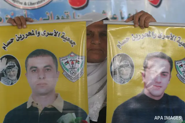 Palestinians hold pictures of their relatives jailed in Israeli prisons during a weekly protest in Gaza City on Dec 28, 2009 to call for their release. Currently Israel is holding 11,000 Palestinians in its jails. Photo...