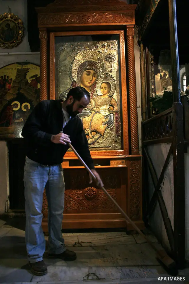 Orthodox priest cleans the Church of the Nativity in the biblical West Bank city of Bethlehem on December 29, 2009 as part of the preparations for the Orthodox faith's Christmas celebrations. The Orthodox faith in the ho...