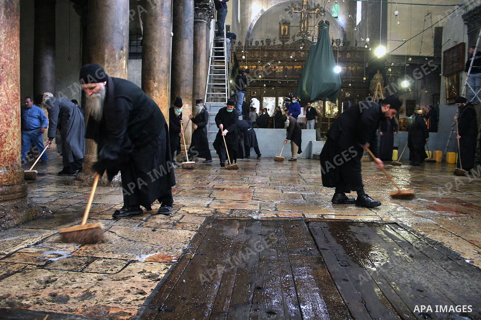 Orthodox priests clean the Church of the Nativity in the biblical West Bank city of Bethlehem on December 29, 2009 as part of the preparations for the Orthodox faith's Christmas celebrations. The Orthodox faith in the ho...