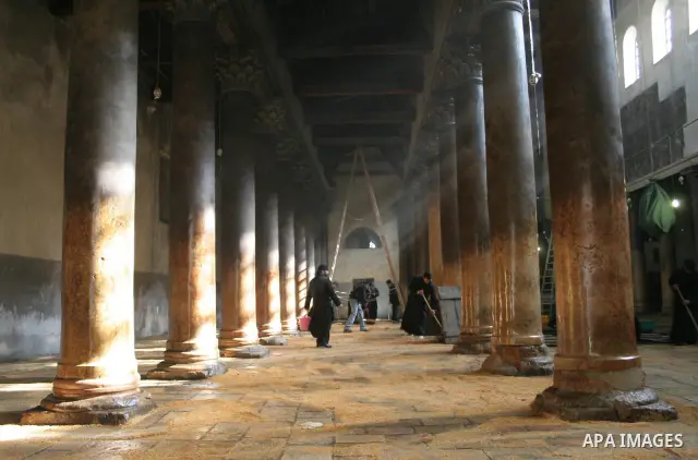 Orthodox priests clean the Church of the Nativity in the biblical West Bank city of Bethlehem on December 29, 2009 as part of the preparations for the Orthodox faith's Christmas celebrations. The Orthodox faith in the ho...