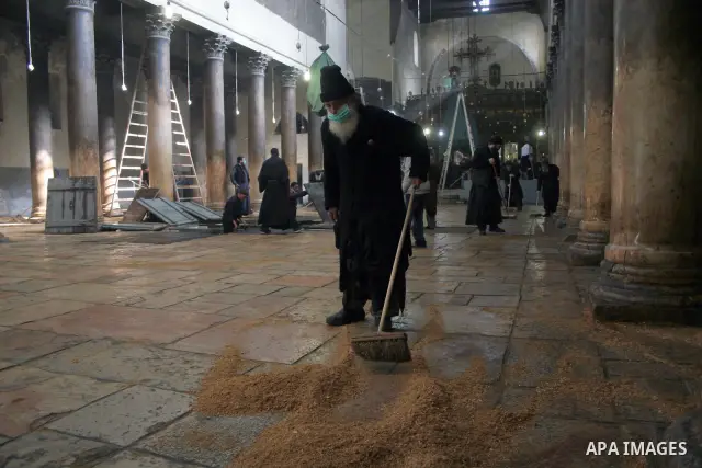 Orthodox priests clean the Church of the Nativity in the biblical West Bank city of Bethlehem on December 29, 2009 as part of the preparations for the Orthodox faith's Christmas celebrations. The Orthodox faith in the ho...