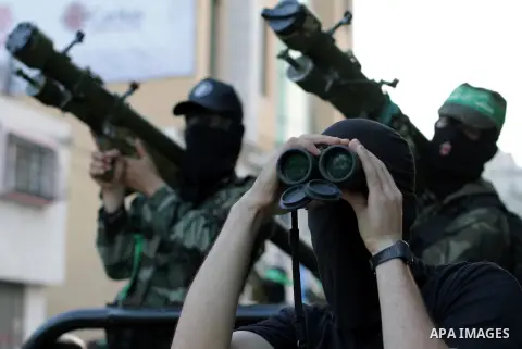 Palestinian militants of the Ezzedine al-Qassam Brigades, Hamas's armed wing, stage an anti-Israel parade as part of the celebrations marking the first anniversary of an Israeli army operation in Gaza, on November 14, 20...