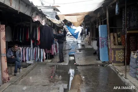 Palestinian vendors work in a flooded market after heavy rains on a stormy day in northen Gaza Strip, December 12, 2013. Streets in Gaza are flooded after only three hours of heavy rain which causes severe infrastructura...