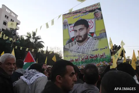 Palestinian supporters of Fatah movement hold the party's torch during a rally in Gaza city on December 31, 2013. Tens of thousands of Fatah supporters rallied in Gaza City on Tuesday to celebrate the 49th anniversary of...