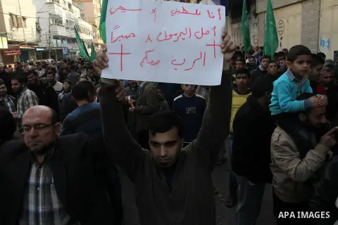 Palestinian supporters of Hamas movement take part in a demonstration in solidarity with Palestinian refugees in Yarmouk refugee camp in the suburbs of the Syrian capital of Damascus, and against resuming peace talks wit...