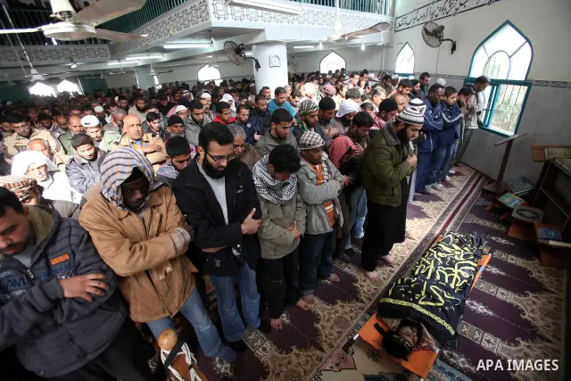 Palestinians pray at the body of militant Awad Abu Naseer during his funeral in Deir Al Balah refugee camp, central Gaza Strip. January 11, 2010. An Israeli air strike in central Gaza killed three Palestinian militants,...