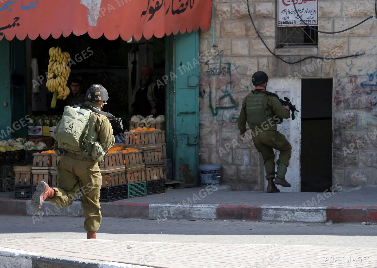 Israeli soldiers take position during clashes with the Palestinian in the West Bank city of Hebron on February 23, 2010. , after Israel's Prime Minister Benjamin Netanyahu was quoted in a statement as saying that the Tom...
