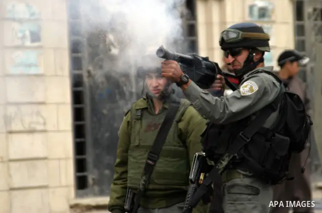 Israeli soldiers take position during clashes with the Palestinian in the West Bank city of Hebron on February 25, 2010. , after Israel's Prime Minister Benjamin Netanyahu was quoted in a statement as saying that the Tom...