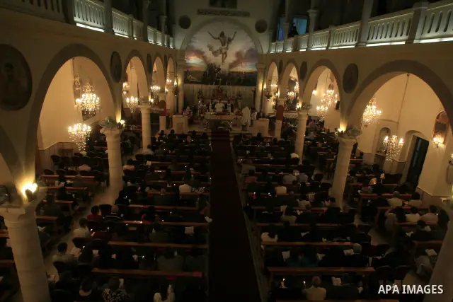Orthodox Christian pilgrims light candles at the Church of the "Der Latins" in the West Bank town of Ramallah on 03 April 2010. Orthodox Christians believe a holy fire appears spontaneously from Jesus' tomb on the day be...