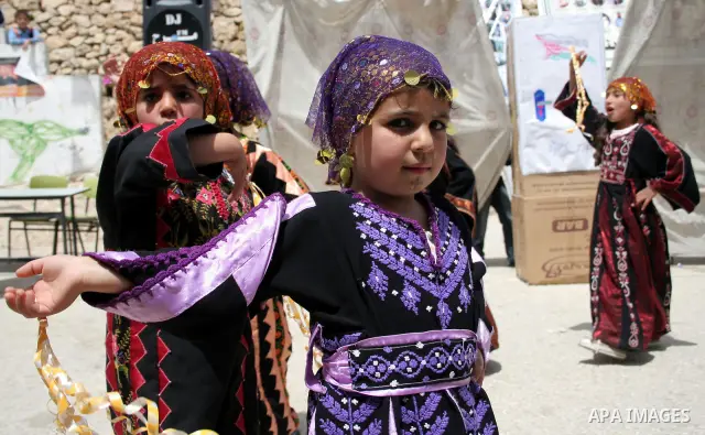 Palastinian dancing girls take part during a demonstration called by students of the Al-Imam Ali School in the West Bank city of Hebron on April 20, 2010. More than 7,000 Palestinians, including 270 who are under the age...