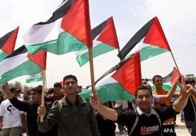 Palestinians take part in a protest near Erez crossing between Israel and the northern Gaza Strip April 21, 2010, against orders introduced by the Israeli military that human rights activists said last week could make al...