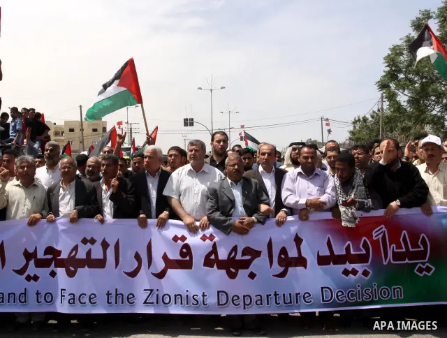 Palestinians take part in a protest near Erez crossing between Israel and the northern Gaza Strip April 21, 2010, against orders introduced by the Israeli military that human rights activists said last week could make al...