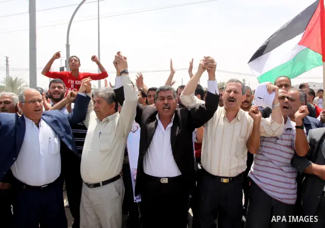 Palestinians take part in a protest near Erez crossing between Israel and the northern Gaza Strip April 21, 2010, against orders introduced by the Israeli military that human rights activists said last week could make al...