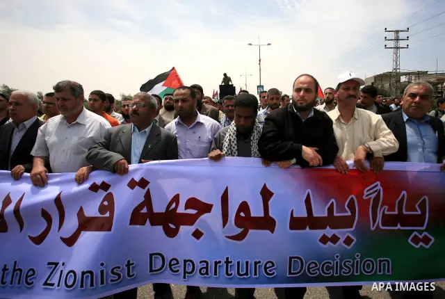 Palestinians take part in a protest near Erez crossing between Israel and the northern Gaza Strip April 21, 2010, against orders introduced by the Israeli military that human rights activists said last week could make al...