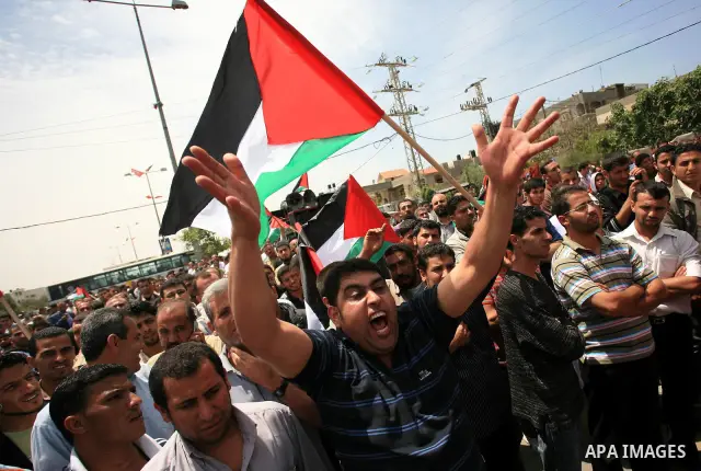 Palestinians take part in a protest near Erez crossing between Israel and the northern Gaza Strip April 21, 2010, against orders introduced by the Israeli military that human rights activists said last week could make al...